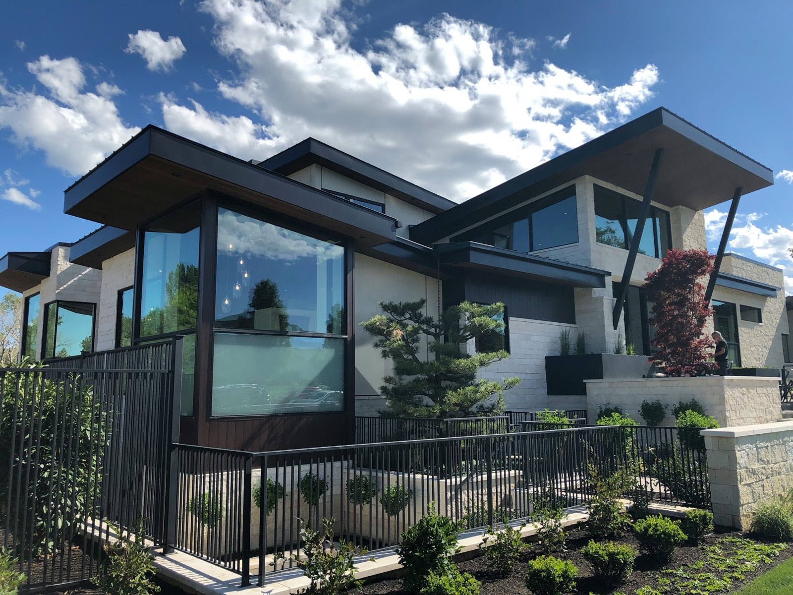 White and brown wooden home beneath a clear blue sky — a welcoming residential exterior ideal for an open house showing