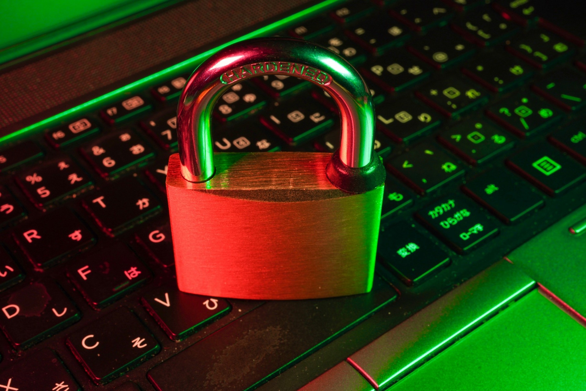 Red padlock placed on black computer keyboard keys — a visual metaphor for data security and privacy in CRM systems